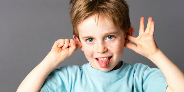 cute little child not listening, sticking out his tongue debt collection agencies