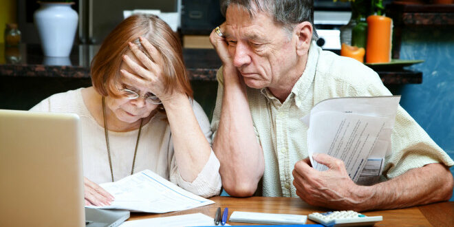 Senior couple at home with many bills dying with debt