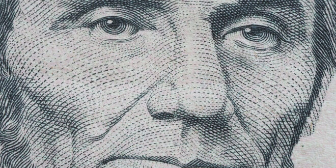 Macro of US dollar series, Abraham Lincoln, a close-up portrait on US five dollars debt collectors