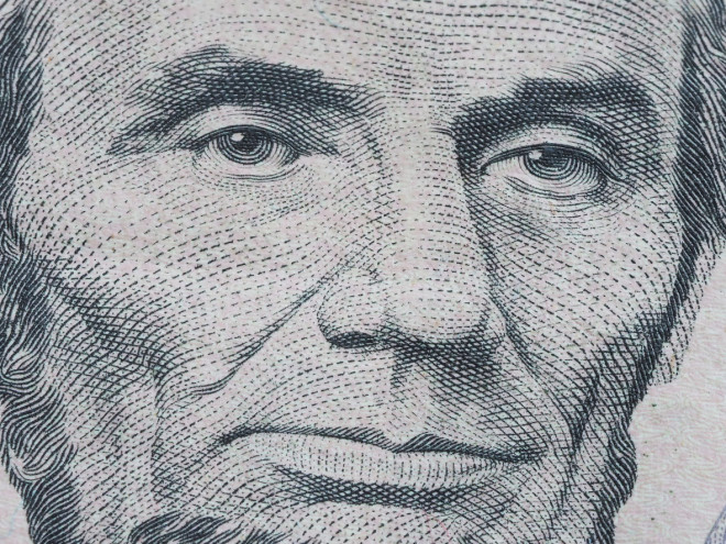 Macro of US dollar series, Abraham Lincoln, a close-up portrait on US five dollars debt collectors