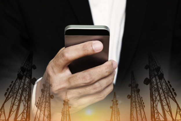 Businessman using mobile phone with multi exposure Telecommunication towers telecommunications debt