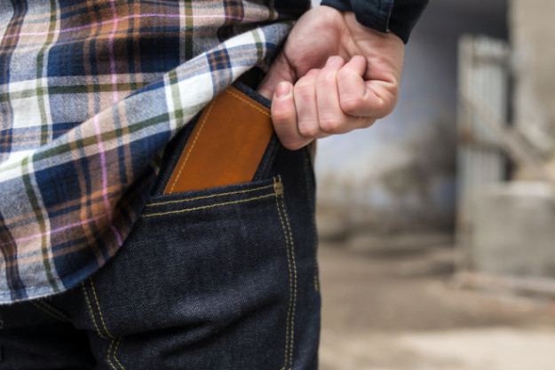 Confident man posing in selvedge  jeans credit card debt