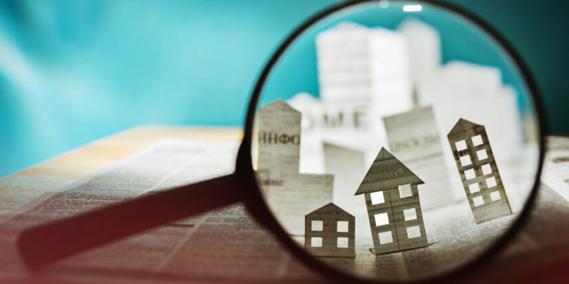 Paper house under a magnifying lens credit managers