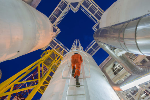 Engineering climb up to oil and gas process plant to observer gas dehydration processing in night shift energy industry accounts receivable