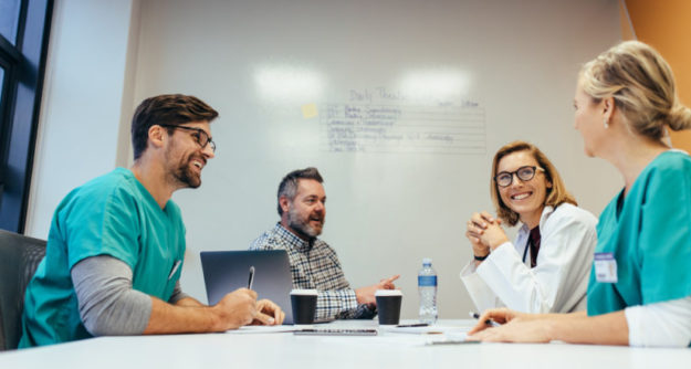 Medical team meeting in conference room medical practice management