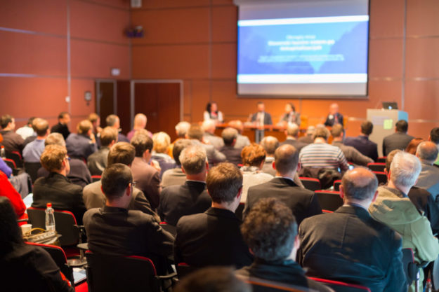 Audience at the conference hall. optio solutions
