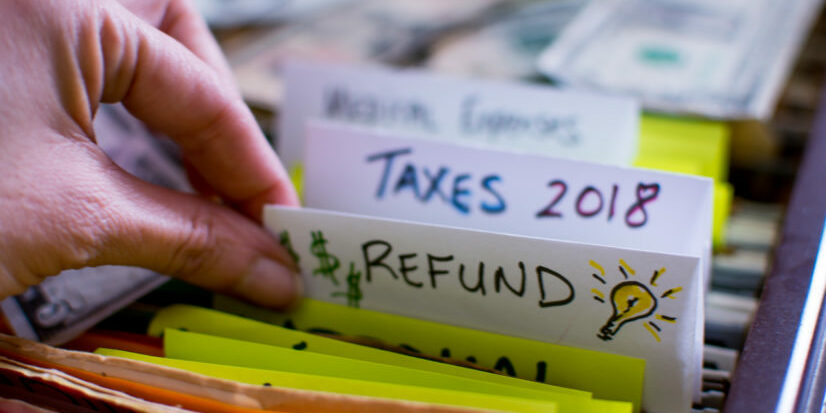 Woman pulling out file on Tax season 2018 Tax refund tax season strategy