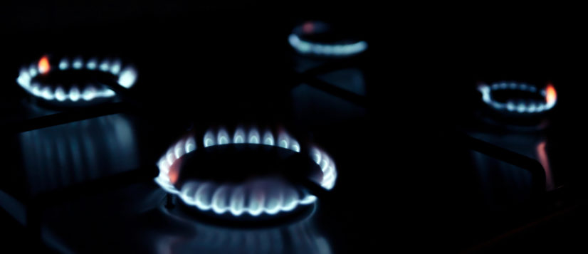 Gas kitchen stove cook with blue flames burning