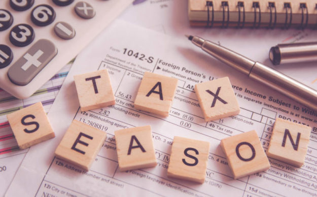 Alphabet letter wooden blocks tiles Tax season with on U.S. tax form tax season debt collection strategy