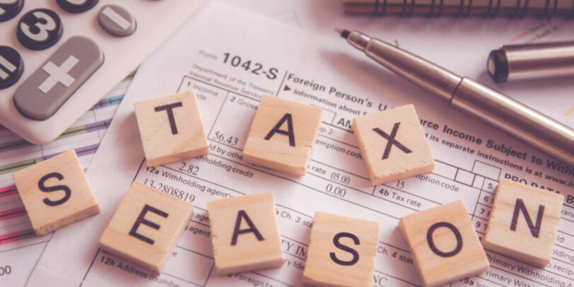 Alphabet letter wooden blocks tiles Tax season with on U.S. tax form tax season debt collection strategy