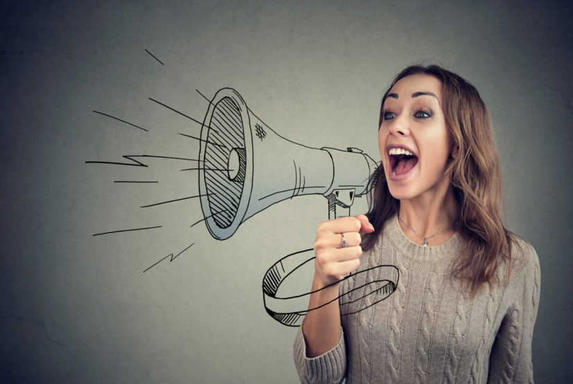 Cheerful woman sharing with news using loudspeaker commercial collectors