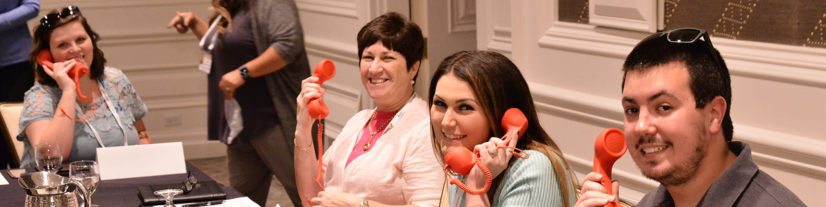 Smiling Senior-Level Creditors Practice Phones at CRS