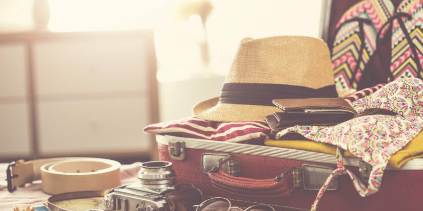Suitcase packed full vacation supplies