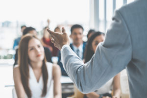 Speaker talking in seminar to several individuals