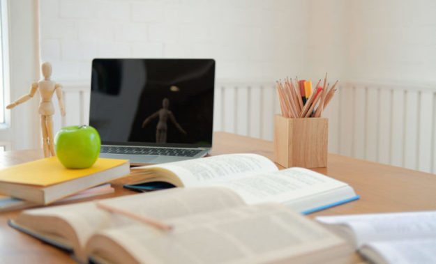 book computer on desk table for studying. back to school & education concept